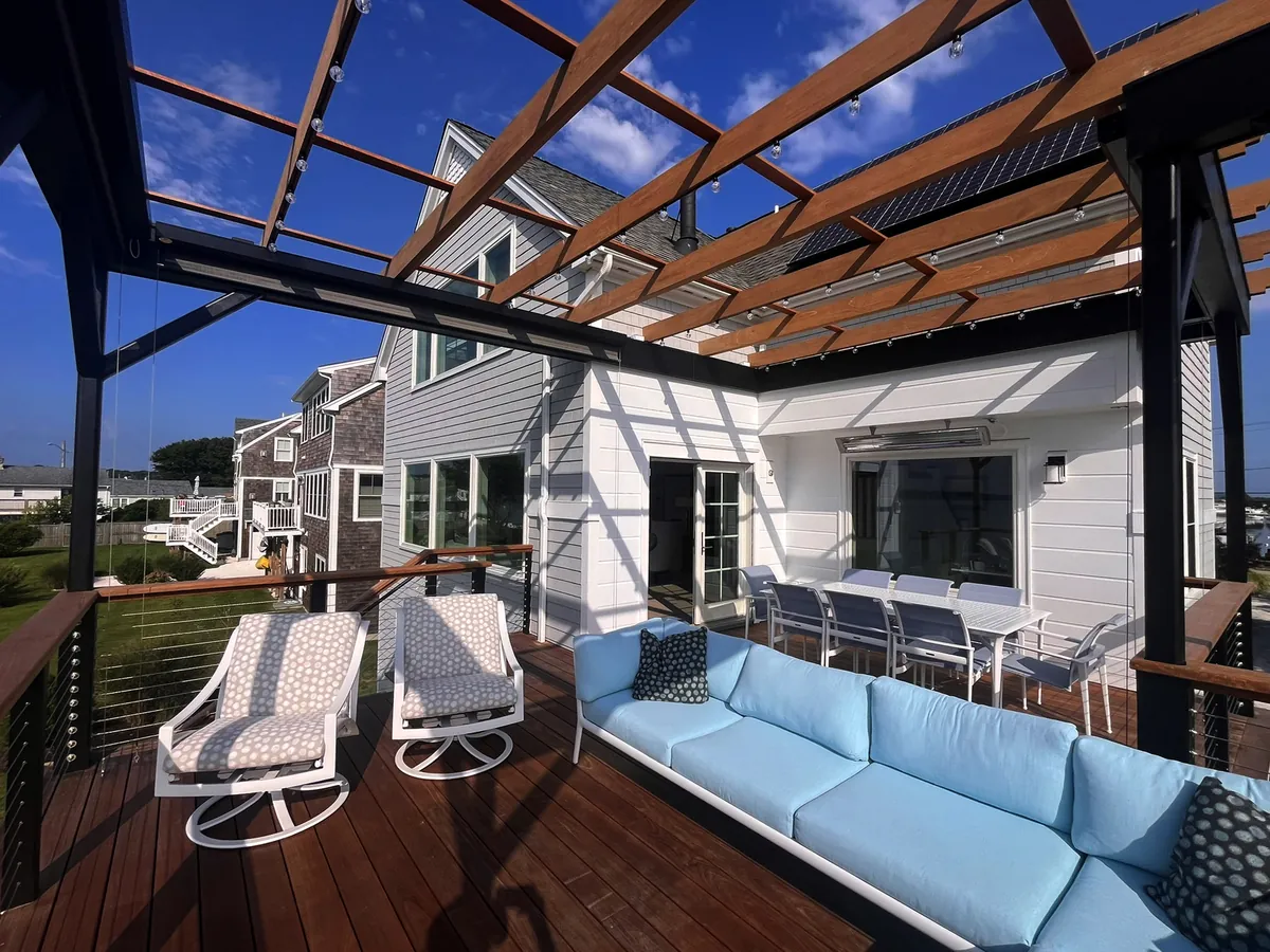 Custom hardwood deck with black metal pergola and outdoor seating