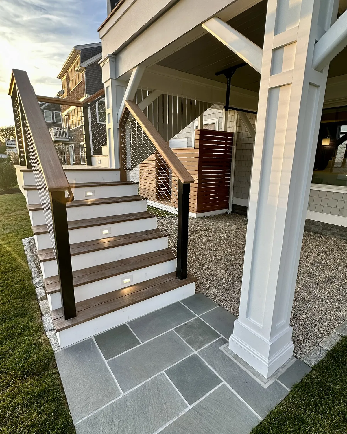 Custom deck stairs with cable railing and integrated step lighting