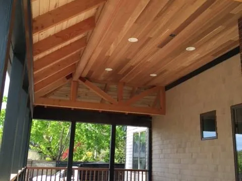 Fir post and beam ceiling inside a Newport screened porch with cedar shingle exterior walls